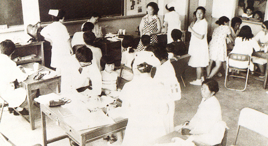 Volunteers examining patients