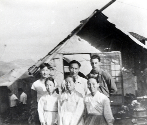 Reverend Moon in front of the mud-wall hut with the first American to hear his teachings